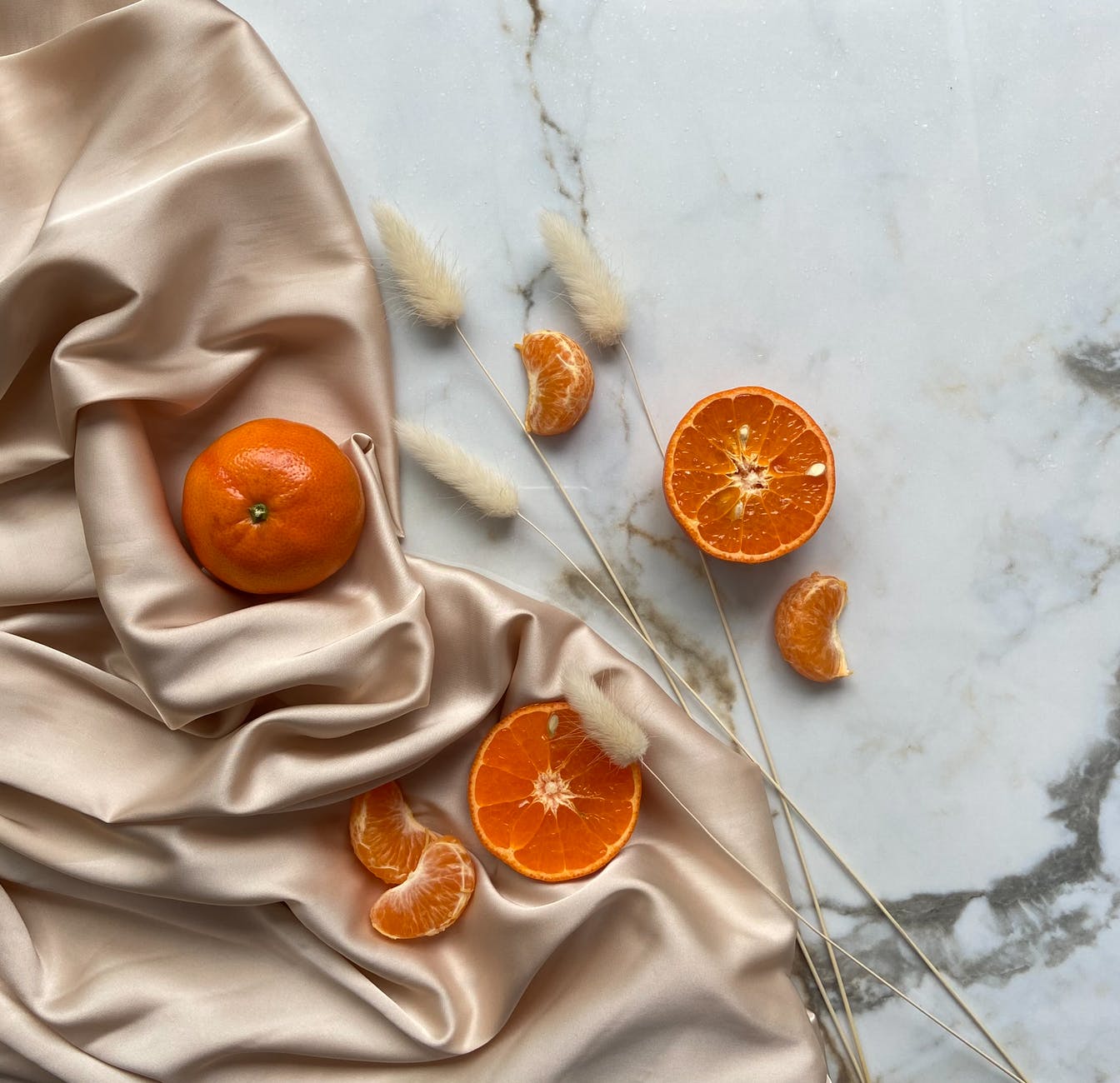 delicious tangerines and oranges on silk fabric
